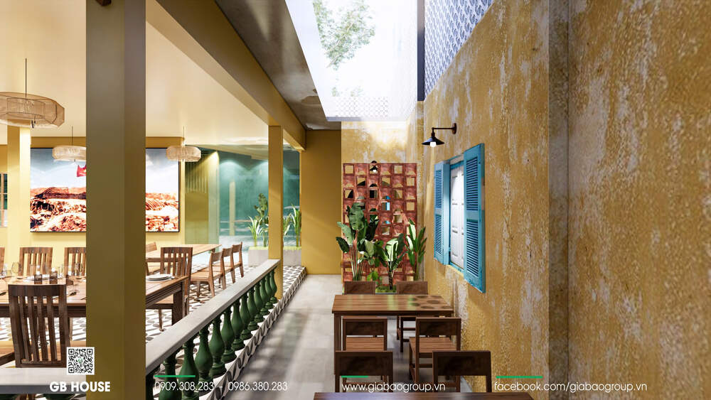 Khu bàn nhỏ cạnh cửa sổ xanh tạo điểm nhấn vintage cho không gian quán
